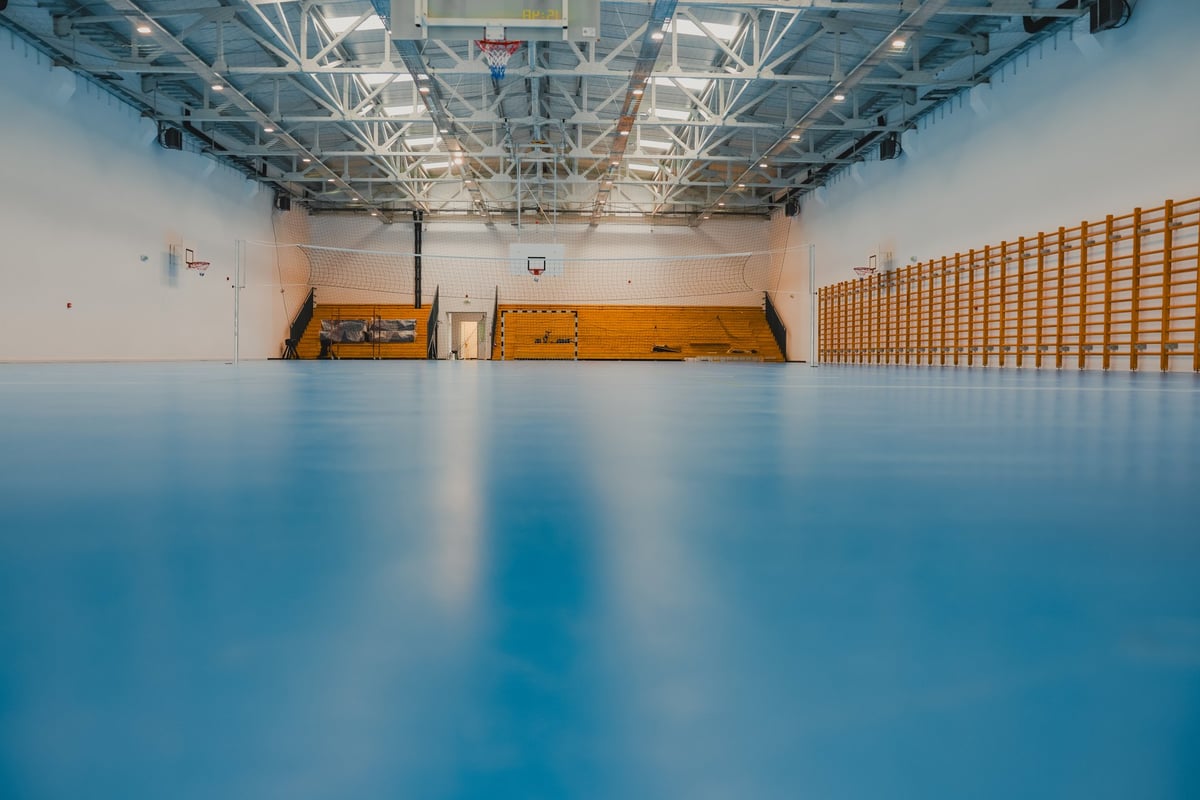 Spacious commercial interior with a continuous resin floor finish in a neutral tone