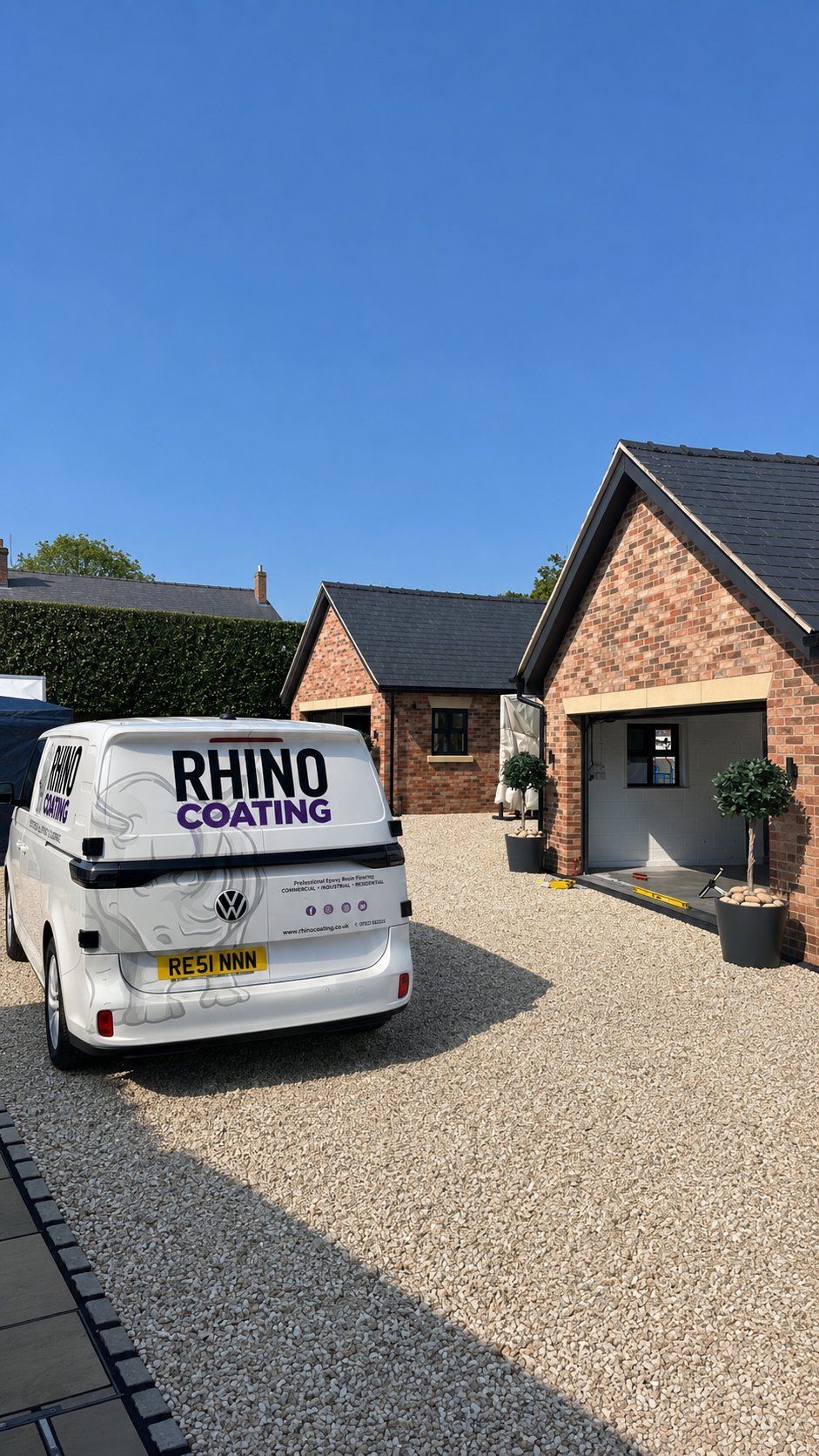 White Rhino Coating service van parked in front of a brick residential home with driveway under clear blue sky
